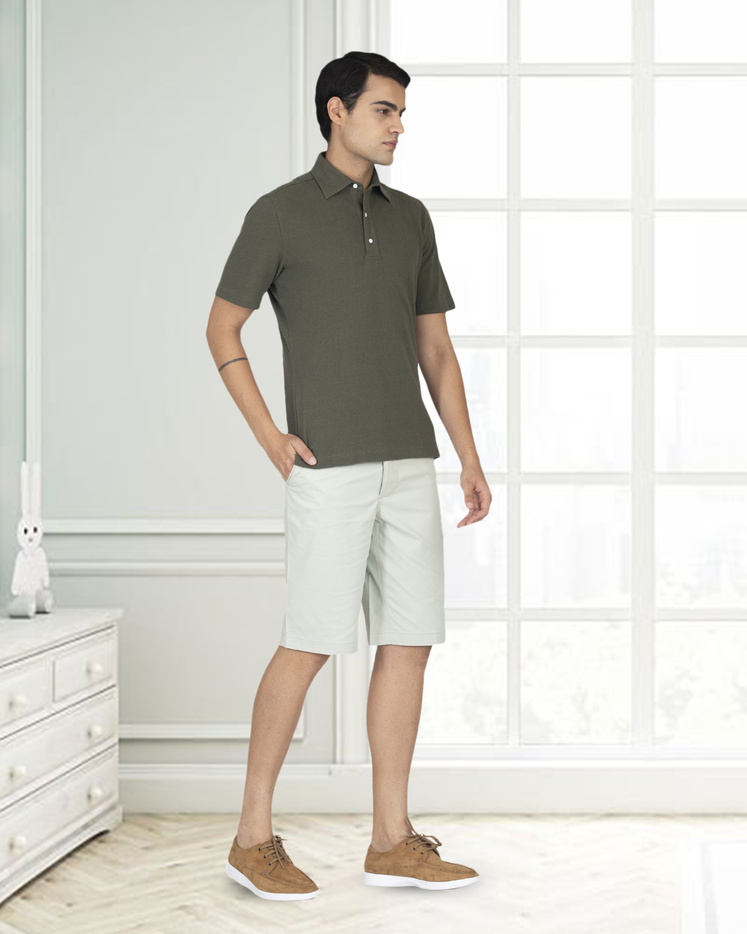 Front of model wearing the custom oxford polo shirt for men by Luxire in olive green hands at side 3