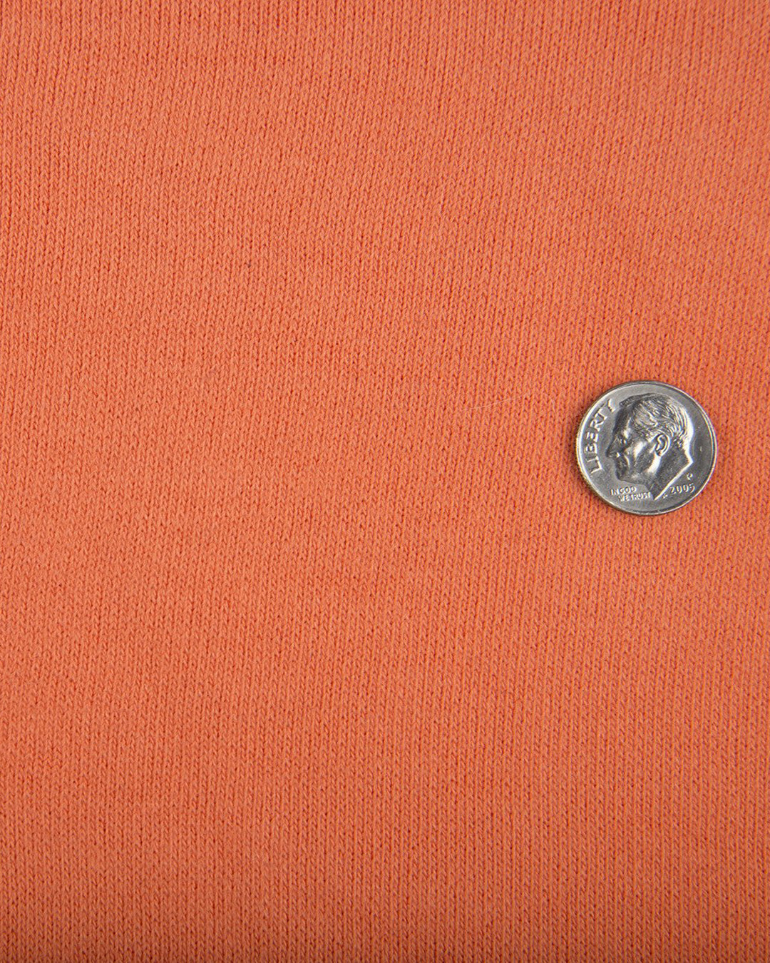 Close up of the custom oxford polo shirt for men by Luxire in bright orange