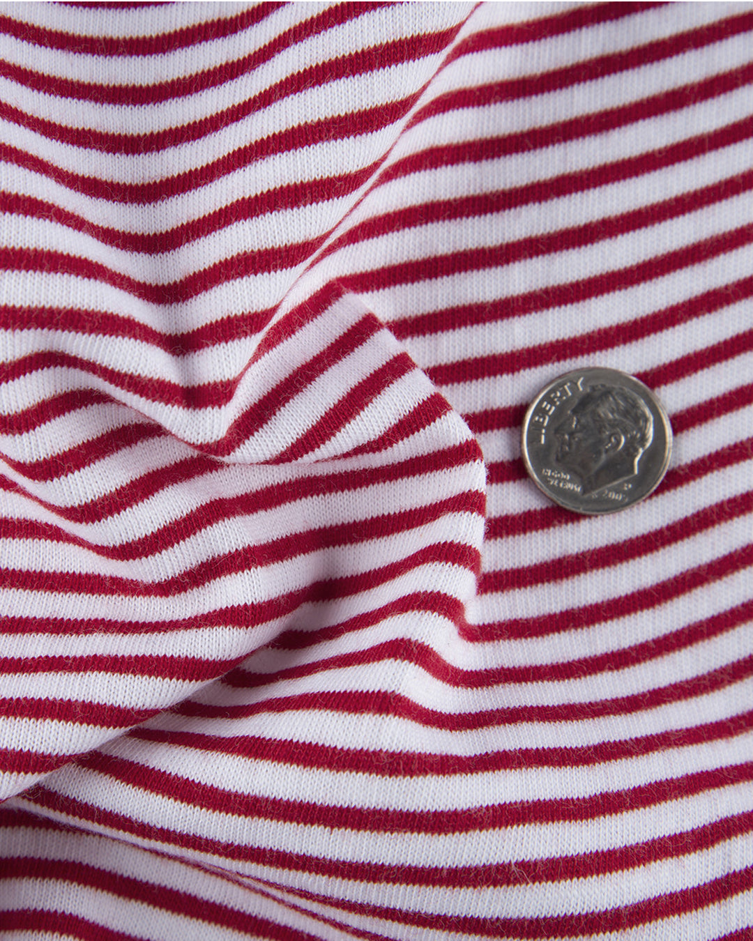 Close up of the custom oxford polo shirt for men by Luxire in white with red candy stripes 2