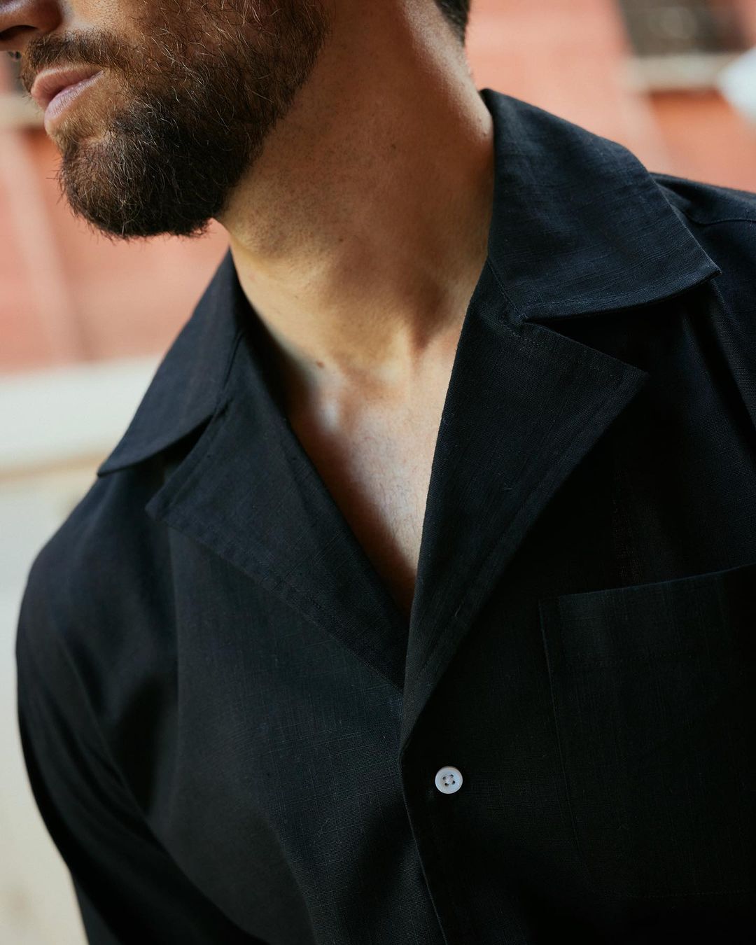 Close up of model wearing the custom linen shirt for men in classic black by Luxire Clothing