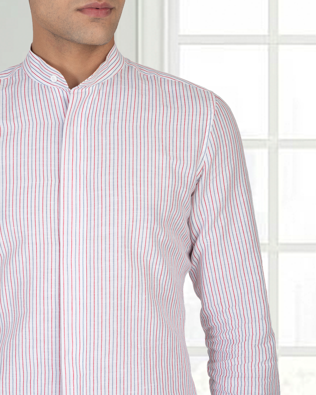 Close up of model wearing the custom linen shirt for men in white with red and blue stripes by Luxire Clothing