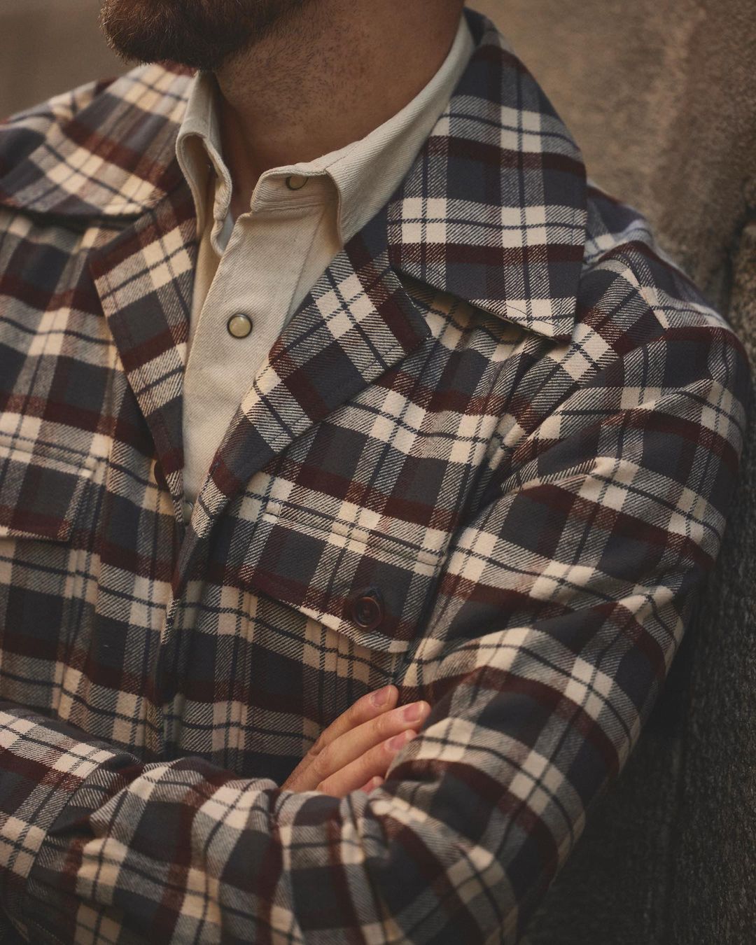 Close up of model wearing the flannel shirt jacket for men by Luxire in brown and ecru checks