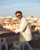 Model outside wearing the linen shirt jacket for men by Luxire in cream wearing sunglasses 10