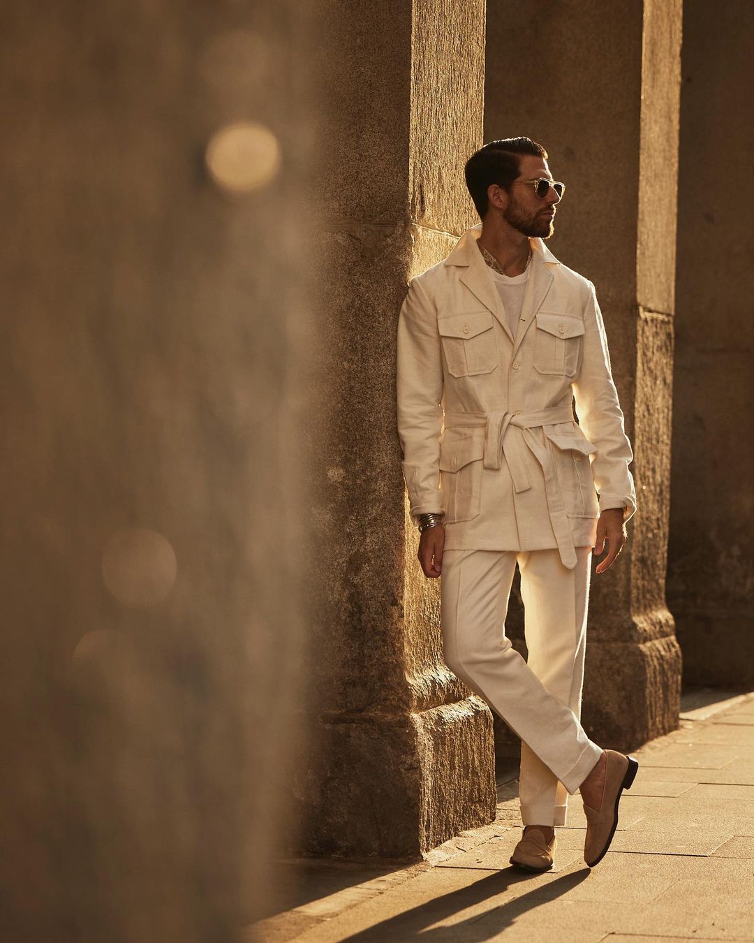 Model outside wearing the safari jacket in linen cotton for men by Luxire in off white
