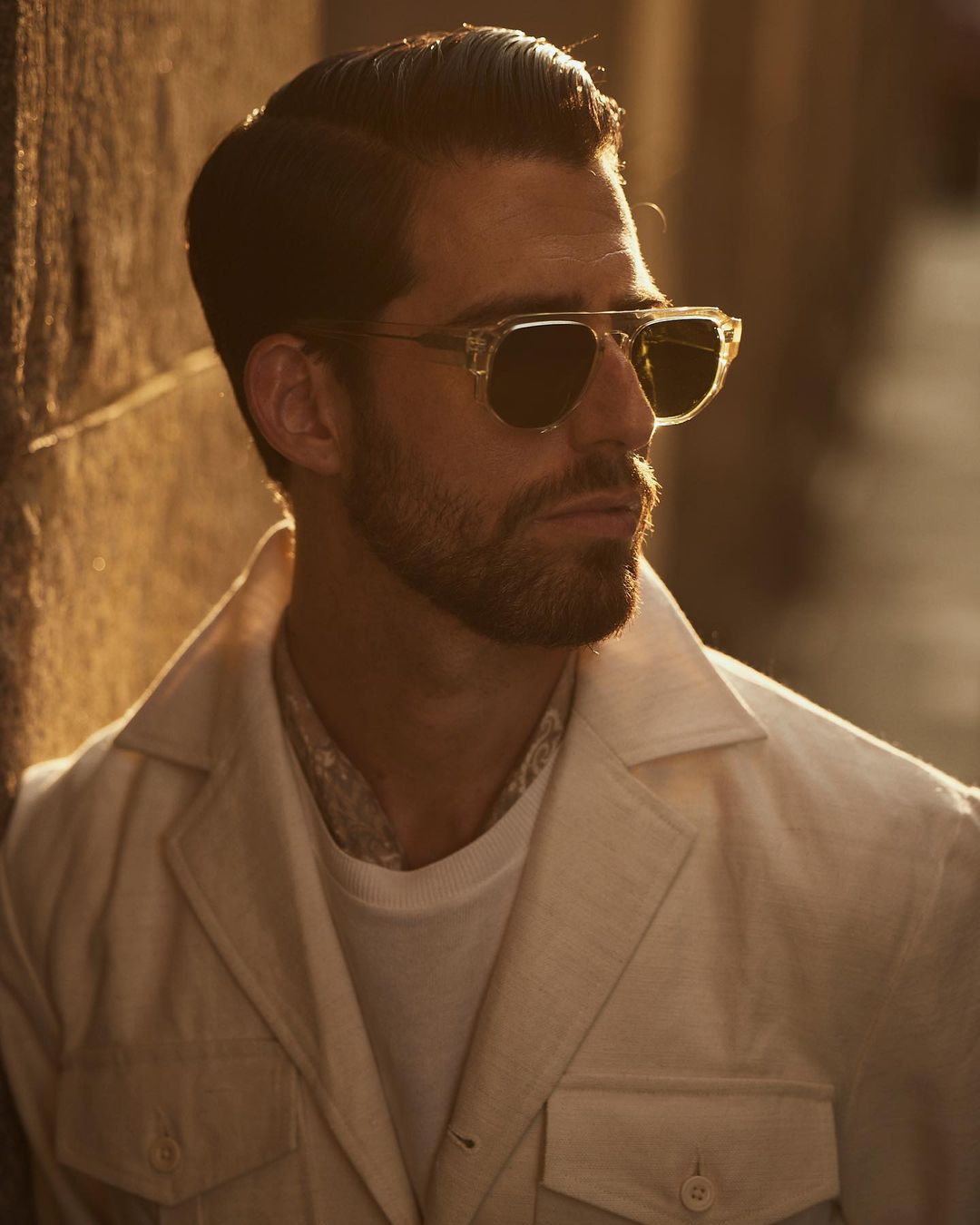 Close up of model outside wearing the safari jacket in linen cotton for men by Luxire in off white
